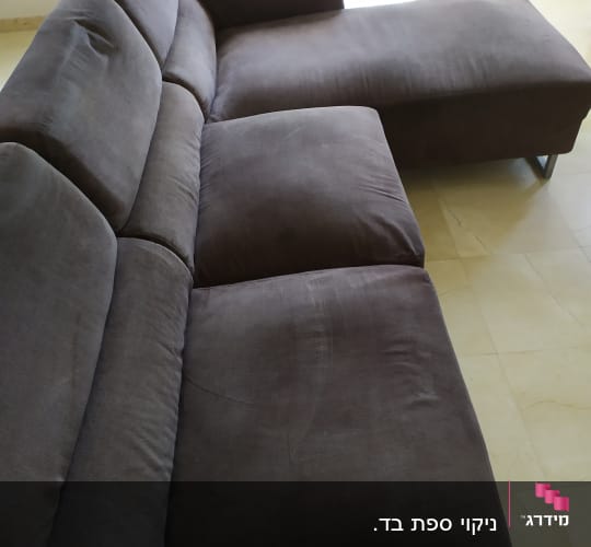 ספה אפורה עם ריפוד בד בחדר מואר